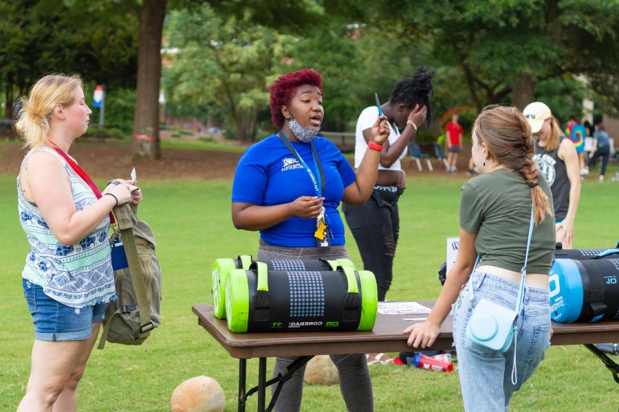 students speaking with uwg employee